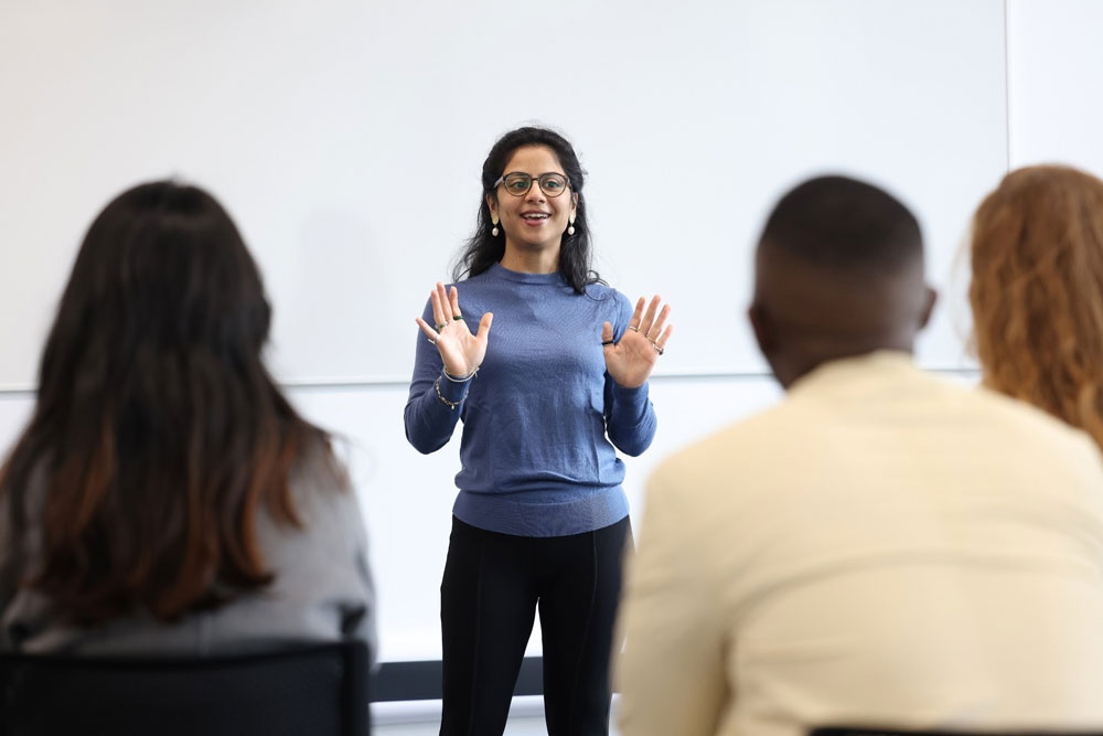 A student standing at the front of a classroom