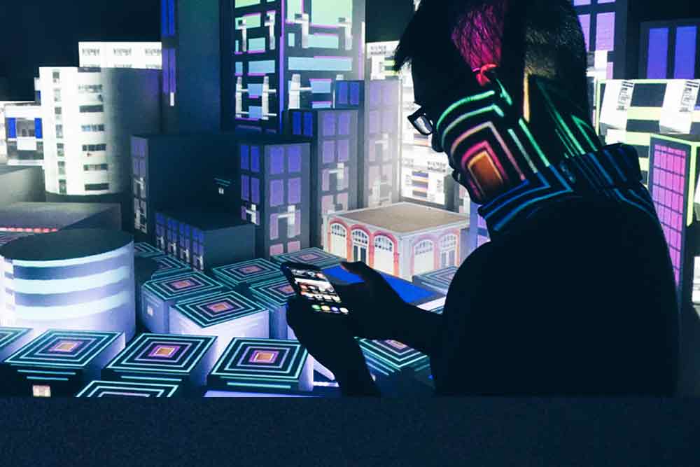 A man in silhouette holding a smartphone