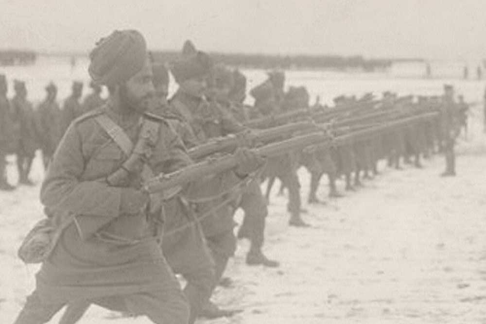 A row of WW1-era Indian soldiers practicing rifle drills.