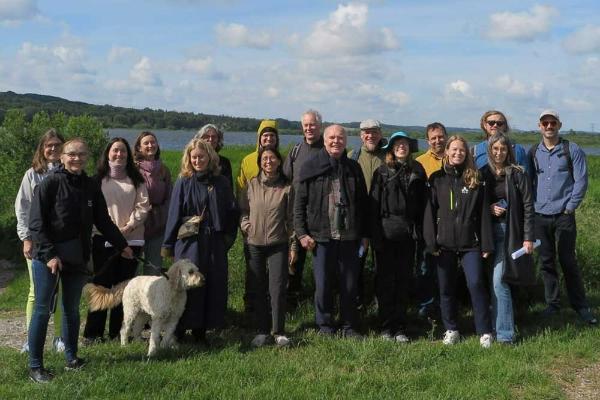 A group of people standing outdoors in the countryside