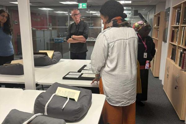 Workshop attendees examining archive items