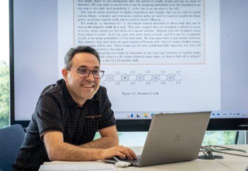 ifam team member at laptop with computer screen in background