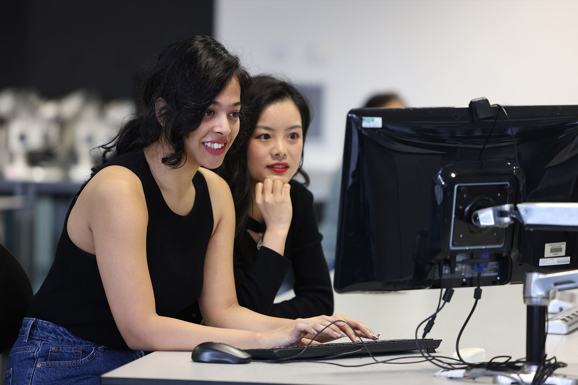 Two female students looking at a computer screen