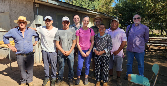 A group photo of Daniel Leybourne and fellow scientists meeting with Chilean farmers