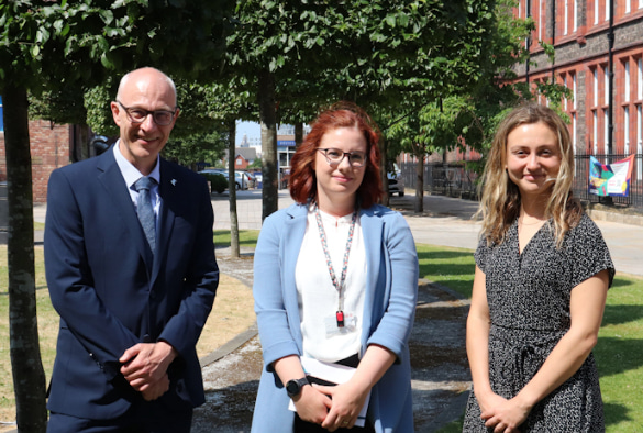 Peter Cotgreate, Tanya Horne and Charlotte Holtum standing in The Quadrangle at the University