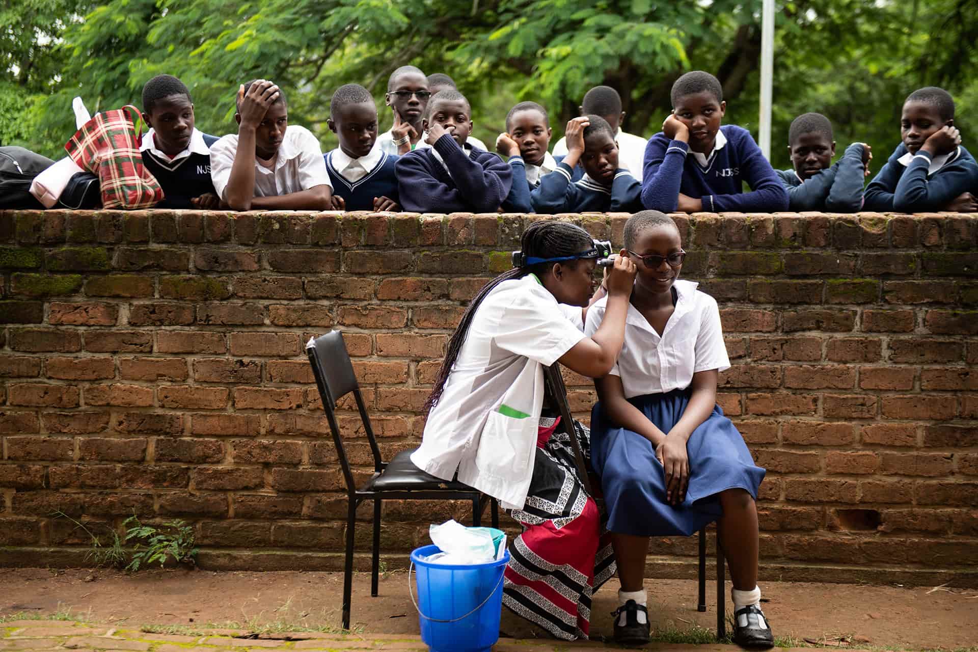 Young person having ear examine in Malawi
