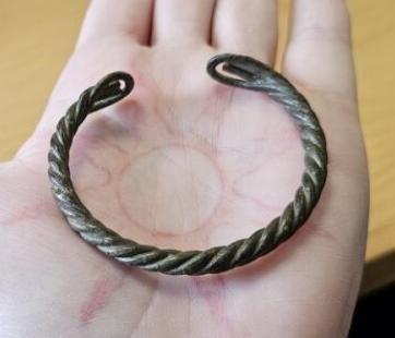 A viking age arm ring, crafted from twisted copper alloy wire