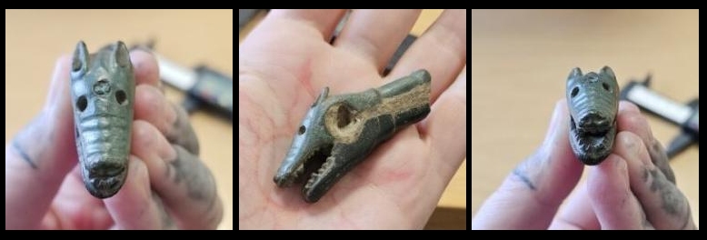 Viking dagger hilt in the shape of a wolf's head, shown in 3 different angles: from the top, the side and the front