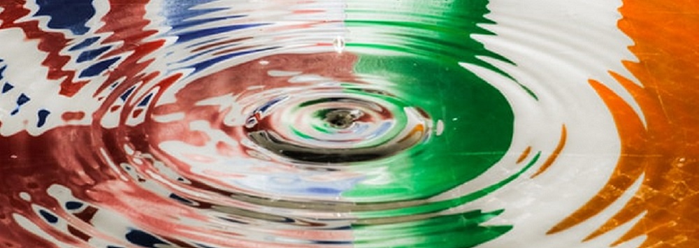 Union Jack and Irish Tricolour reflected in a puddle 