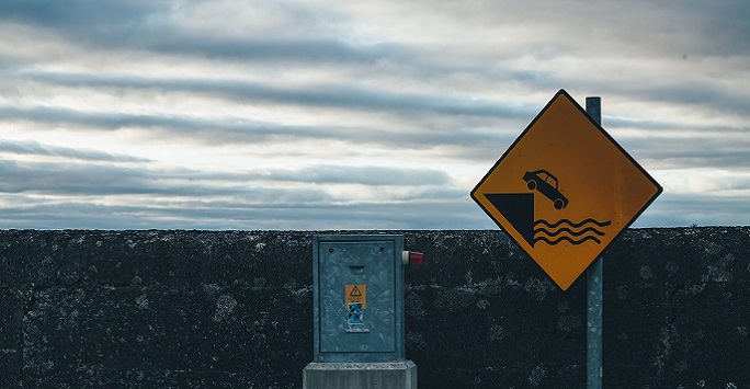 road sign by coastal wall