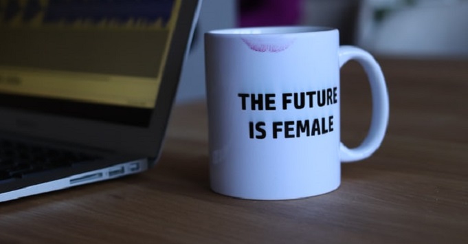 the future is female mug next to a laptop