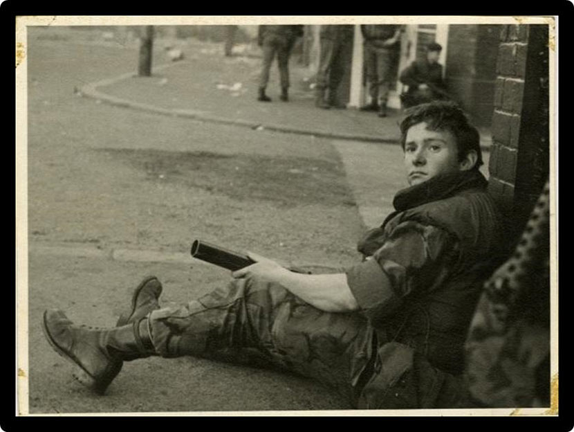 Young soldier sitting in the street