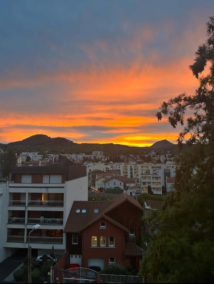 A sunset view overlooking some houses and mountains in France