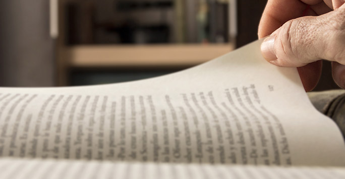 Man reading page of a book