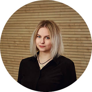 A photo of Iuliia in front of a wooden wall