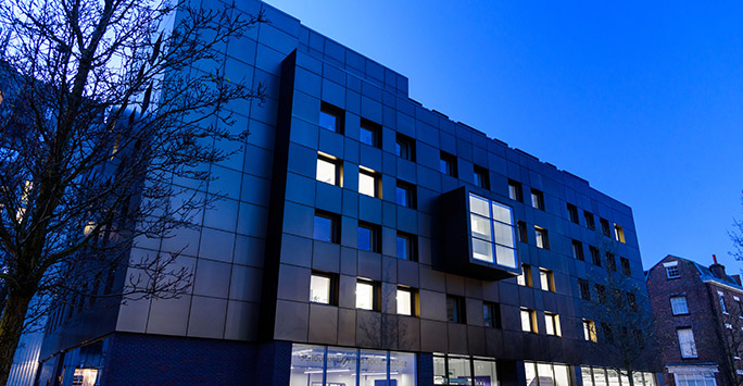 Image of School of Law and Social Justice Building at night