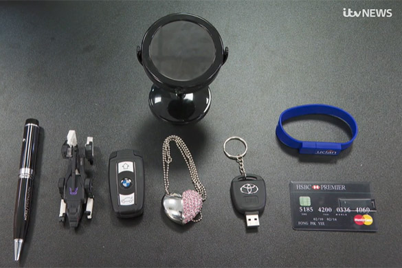 ITV News screenshot featuring seized items including keys, USB sticks, pens and bank cards