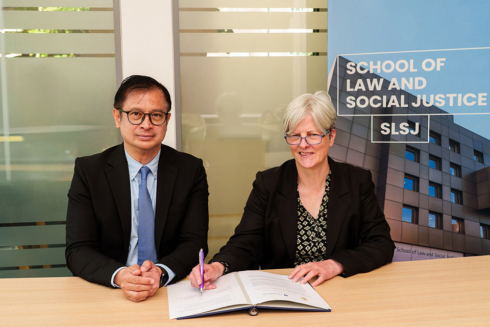 Secretary General Thiratai Charoenwong and Professor Fiona Beveridge signing an MoU