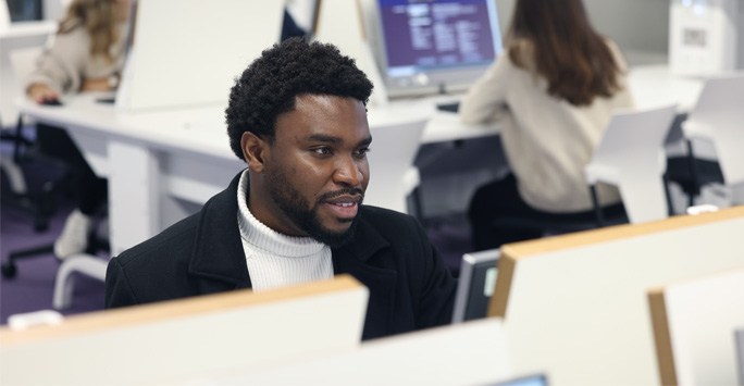 A student sat at a computer.