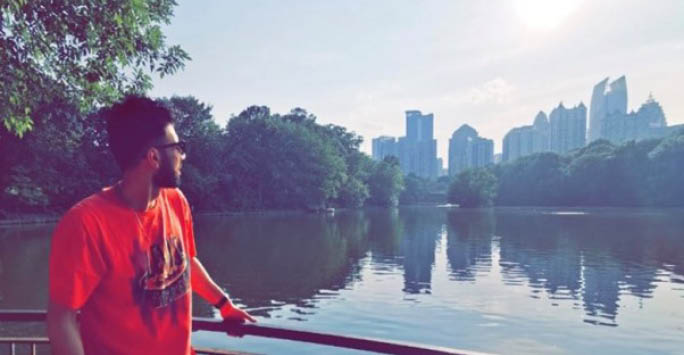 A photo of Ammar Zafar in Georgia in front of the river.