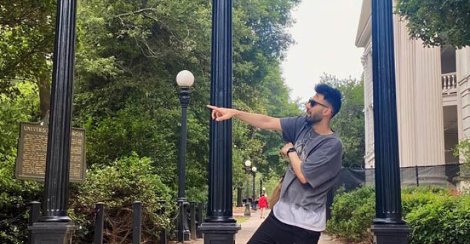 A photo of Ammar Zafar in Georgia in front of the University building.