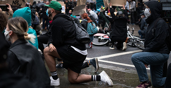 Black Lives Matter protesters in London taking the knee, photographed by James Eades on Unsplash