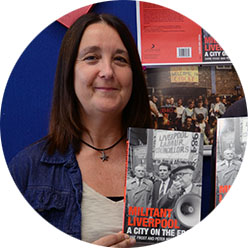 Diane Frost holding up her book 'Militant Liverpool: A City on the Edge'