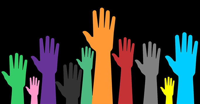 Multicoloured hands in the air - Human Rights symbol