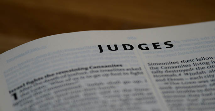 A newspaper with black text saying 'Judges' at the top.