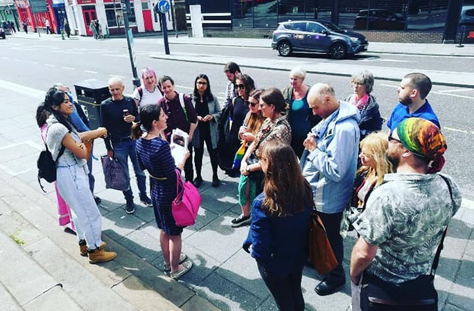 Image of Dr Ahearne delivering a walking tour to a group of people