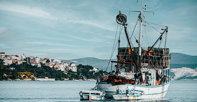 An image of a fishing boat leaving a harbour