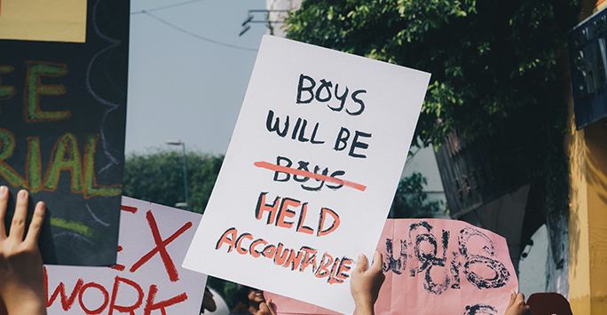 'Boys will be held accountable' sign at a protest