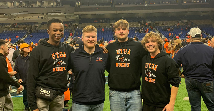 Lloyd with a group of people at a USA Rugby game