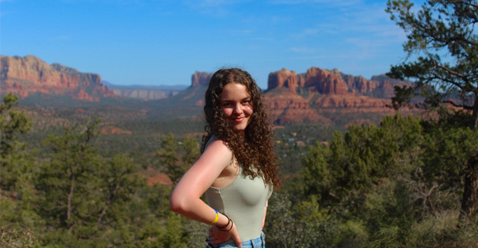 Olivia surround by a red and rocky landscape