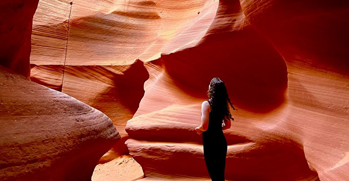 Oliva stood in a cave made of orange coloured rock