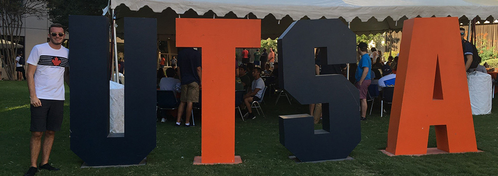 Student with UTSA sign