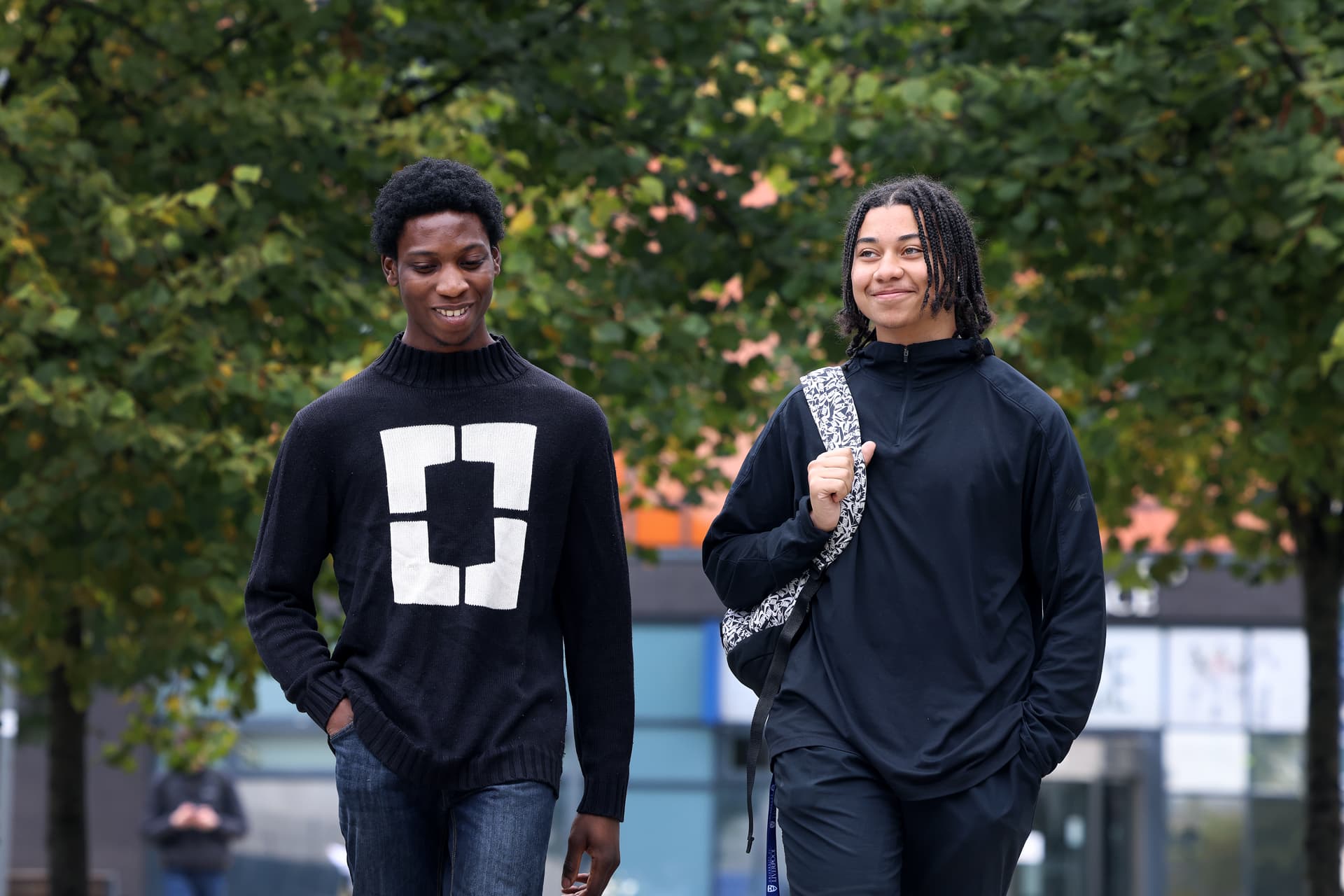 Two students walking through campus.