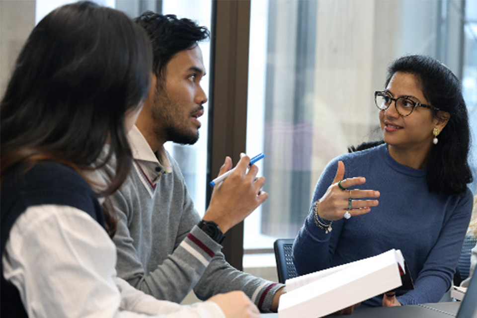 Student in a Seminar sat around a table and talking