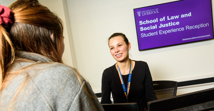 Student at the Studen Experience reception talking to a member of staff.