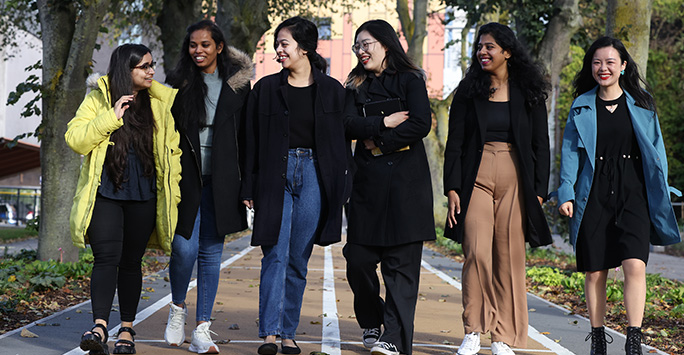 Group of girls walking through university together