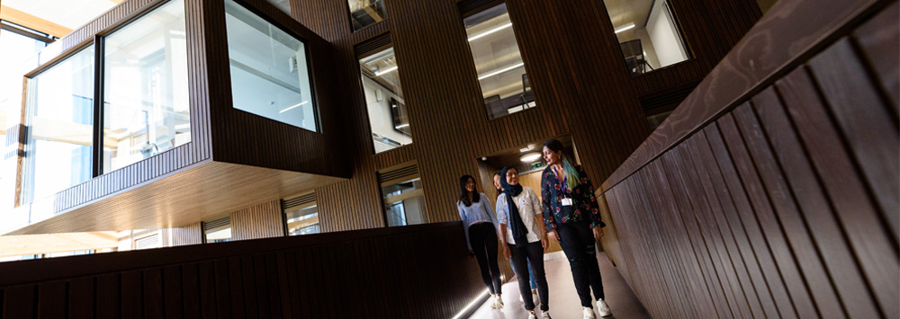 A group of students walking through the School of Law and Social Justice Building