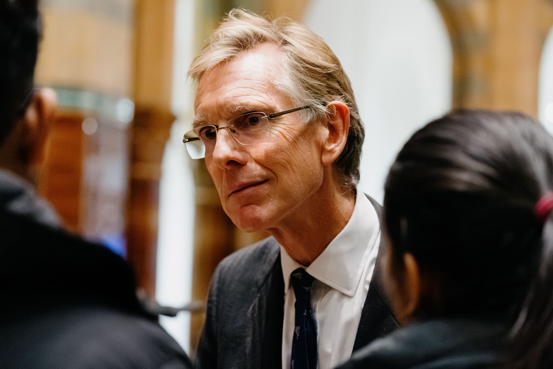 Sit Stephen Cobb, a man with glasses and light-colored hair, dressed in a suit and tie.