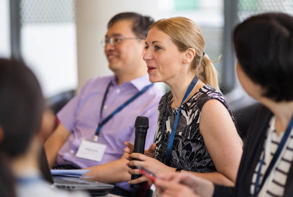 A photo of Andrea Gideon speaking at the ASEAN conference in Singapore.