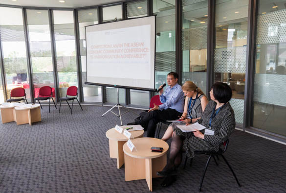 A group of three academics in the conference room.