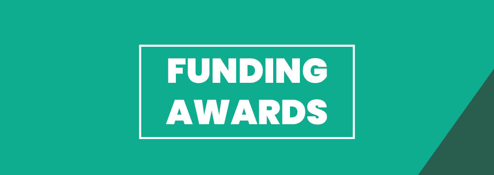 A teal green background with white text that reads 'Funding Awards'.