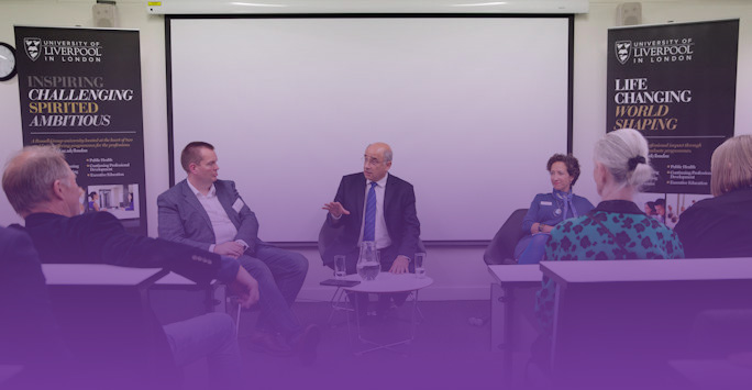 A panel discussion behind a purple tint