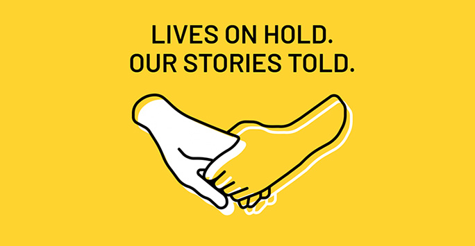 Yellow graphic with an illustration of two holding hands plus black text that reads 'Lives on Hold. Our Stories Told.'