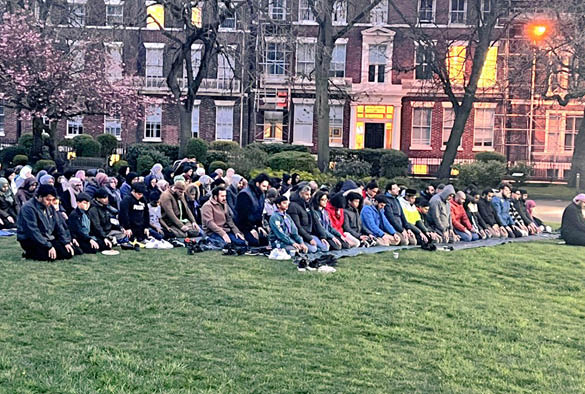 A group of Muslim people praying as part of Ramadan.