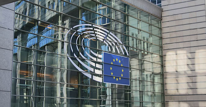 A photo of the European Parliament with the European Union flag.