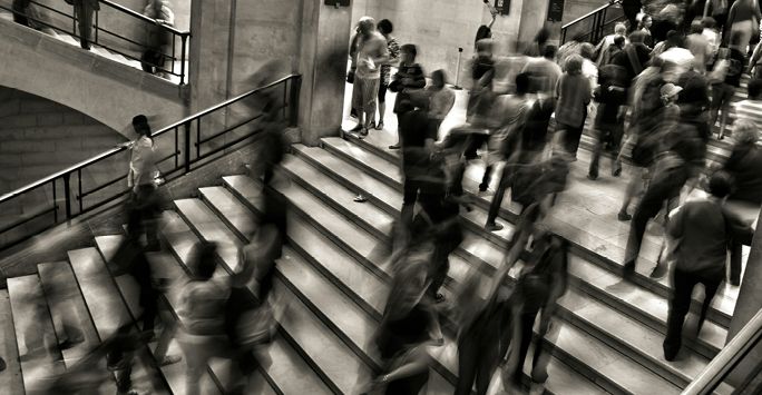 A black and white photograph of a busy street.